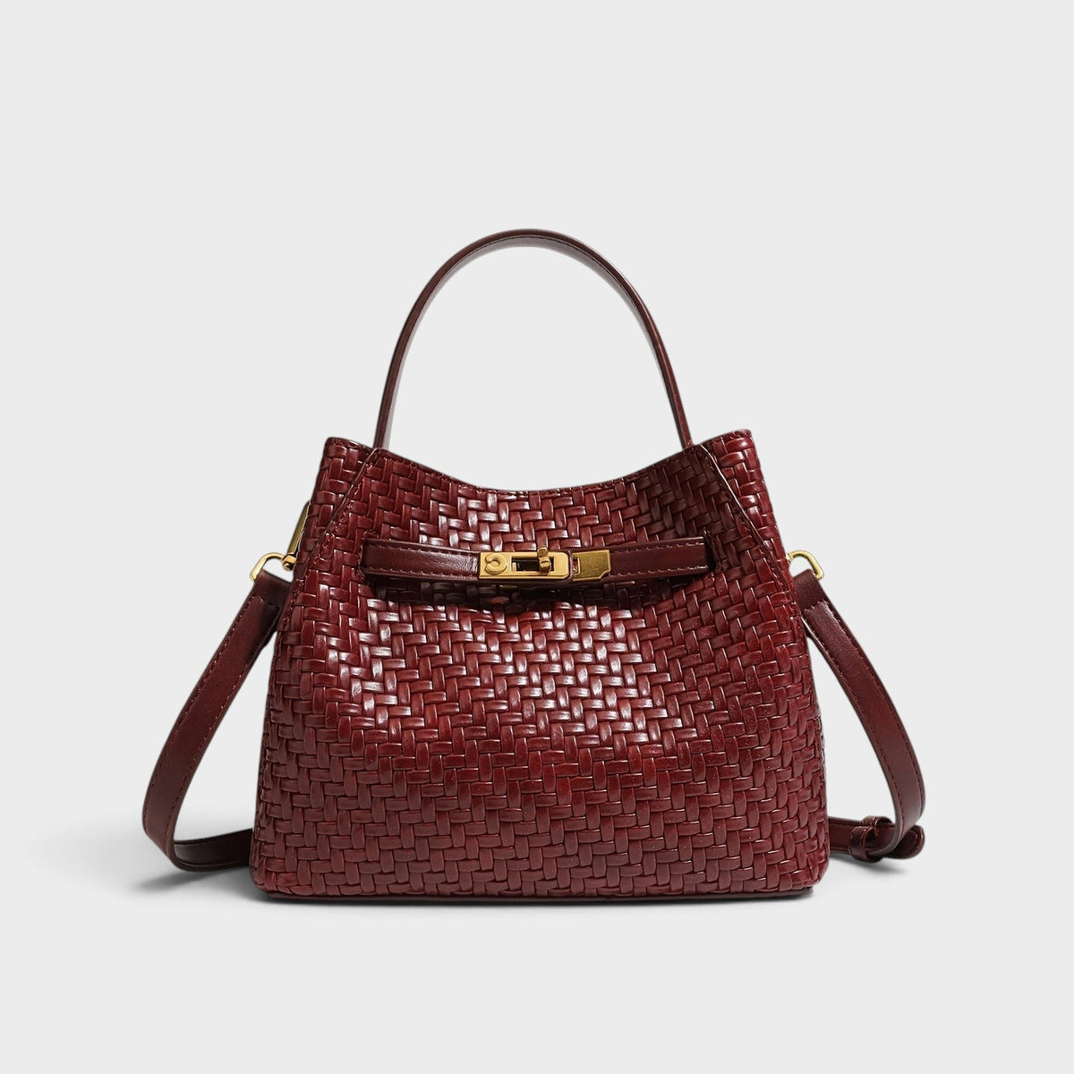 VALENORA Miranda shoulder bag in burgundy woven leather with a gold buckle strap and top handle.