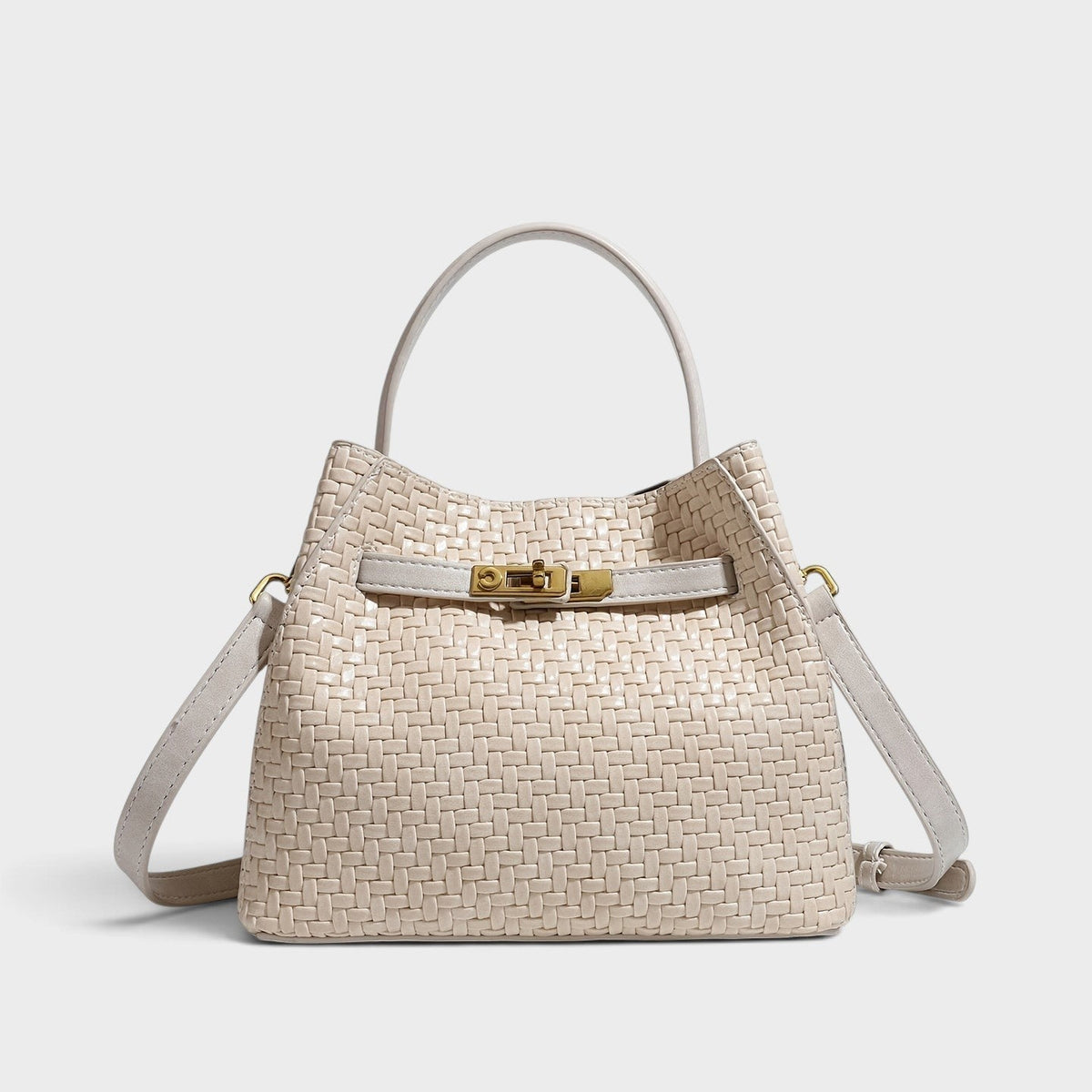 VALENORA Miranda shoulder bag in cream woven leather with a structured silhouette and polished gold buckle hardware.