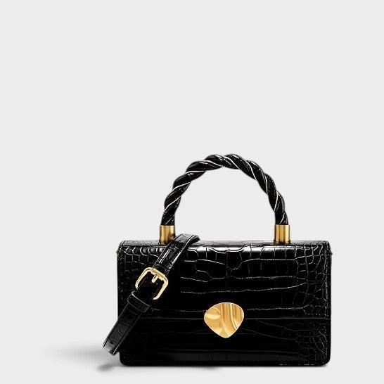 VALENORA Nancy black crocodile-embossed cowhide leather shoulder bag with a twisted handle and gold hardware.