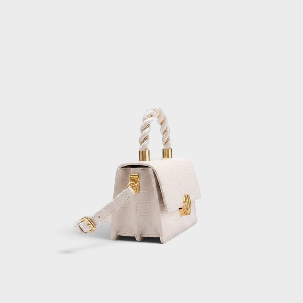 VALENORA Nancy white shoulder bag in croc-embossed cowhide leather with a braided top handle and gold hardware.