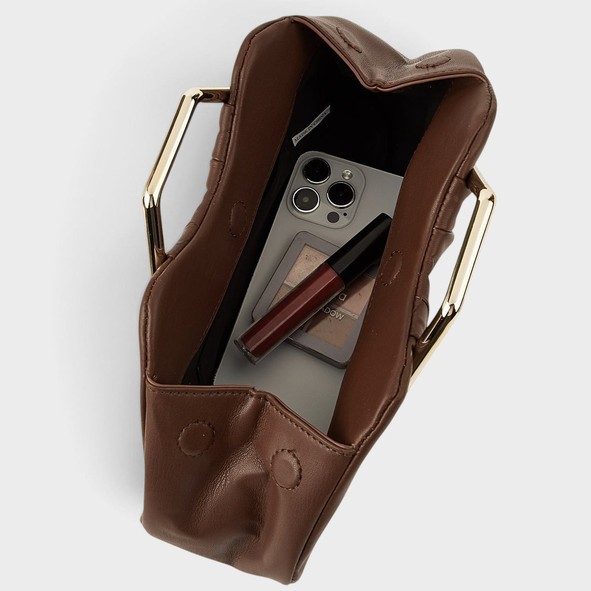 VALENORA Natalie handbag in coffee brown vegan leather with a polished gold metal handle, shown from an open top view.