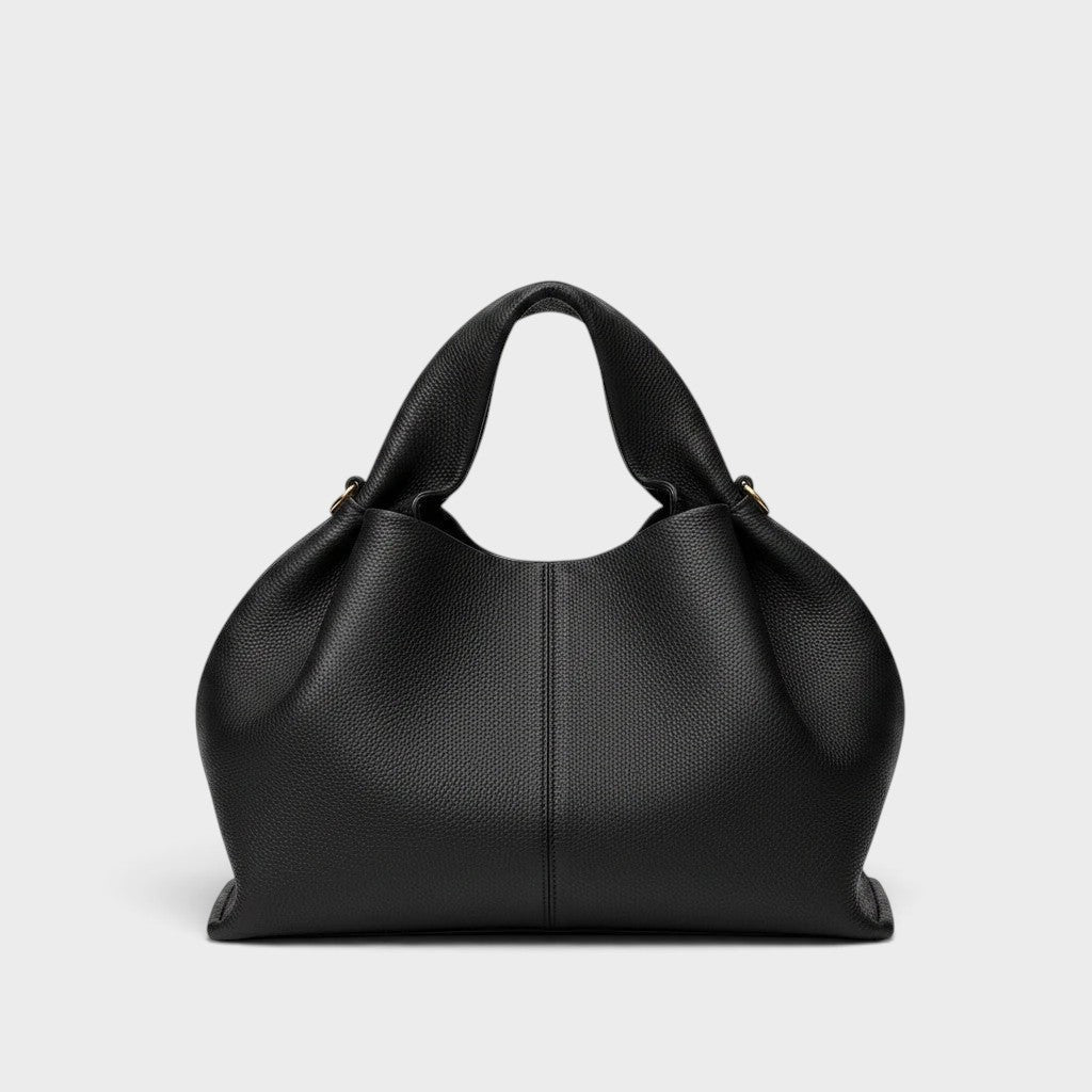 VALENORA Nova black vegan leather tote bag with a soft, pebbled texture and structured handles.