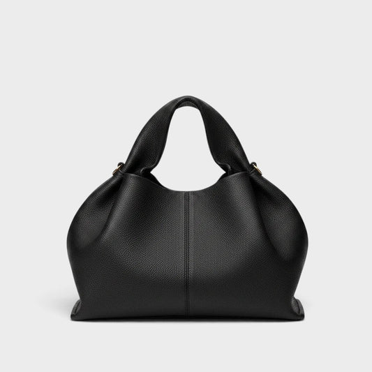 VALENORA Nova black vegan leather tote bag with a soft, pebbled texture and structured handles.