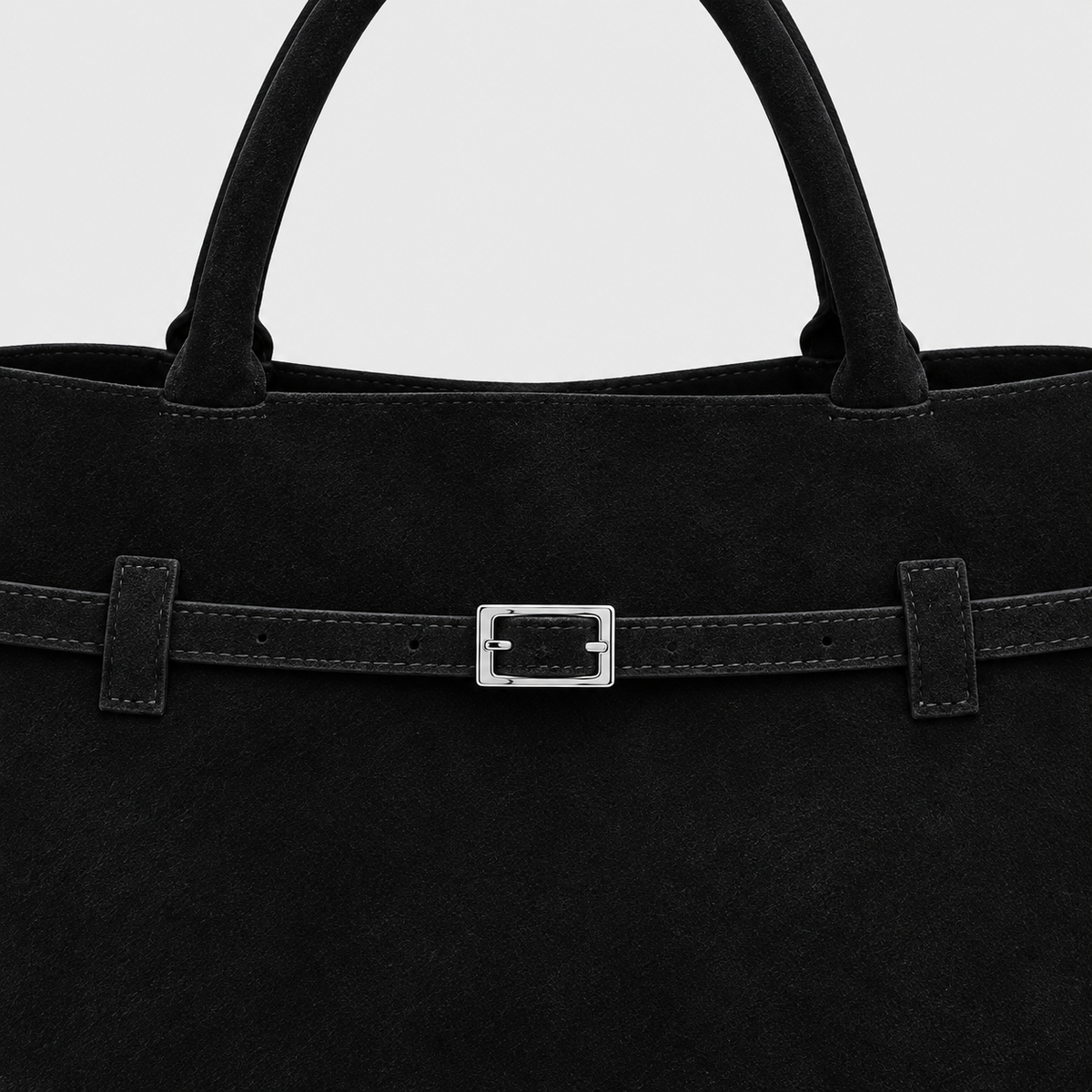 VALENORA Ramona black suede tote bag featuring a decorative slim belt strap with a polished silver buckle detail.