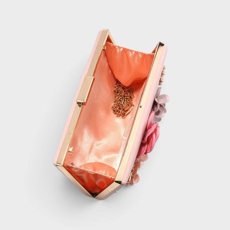 VALENORA Rosalind clutch bag interior view showing soft peach lining, gold chain strap, and floral exterior detail.