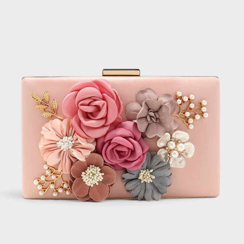 VALENORA Rosalind clutch bag in blush pink with fabric floral embellishments, pearl accents, and gold leaf details.