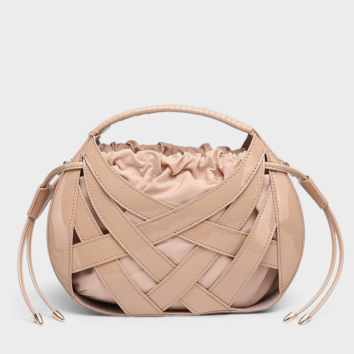 VALENORA Ruby handbag in beige vegan leather featuring a structured lattice overlay and soft drawstring pouch interior.