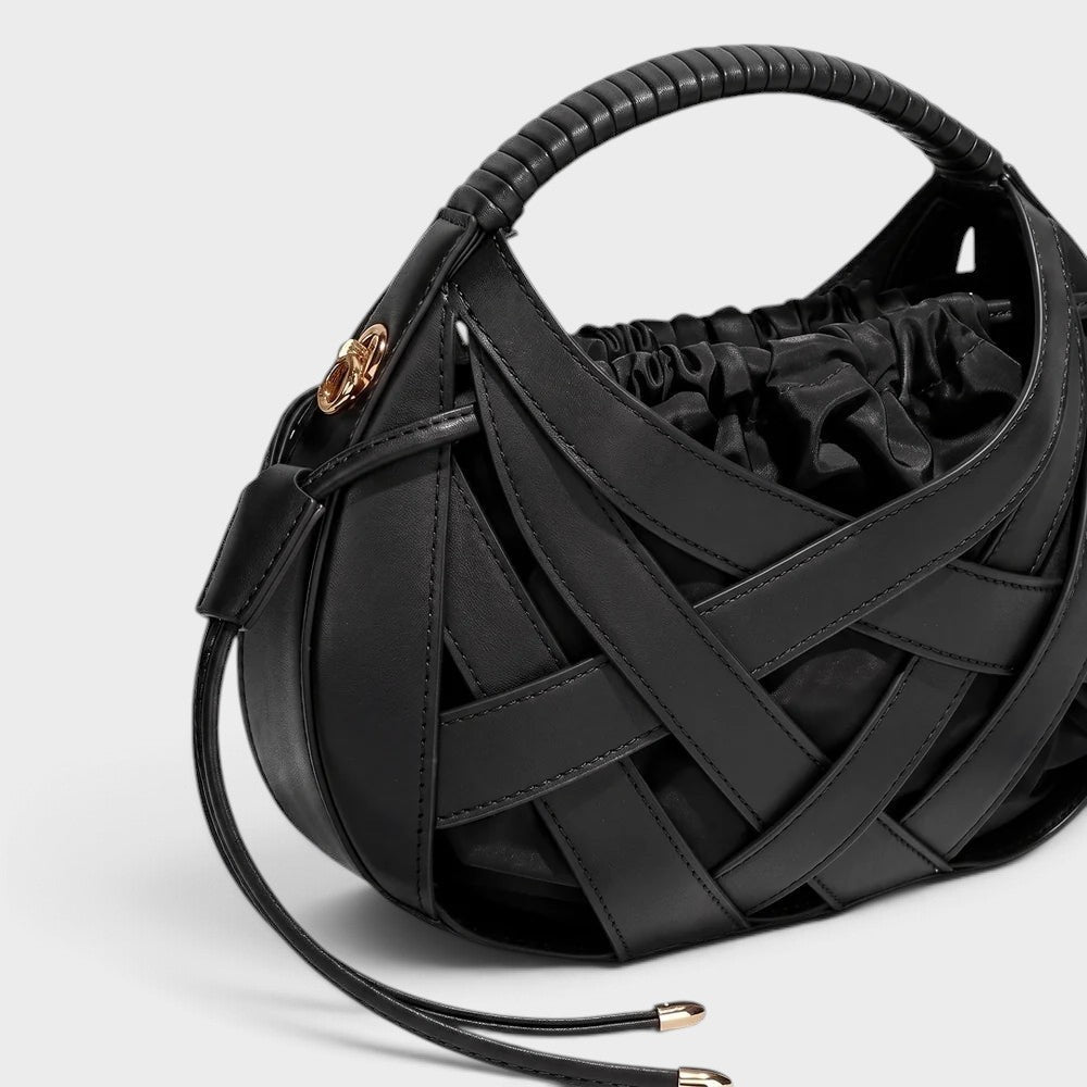 VALENORA Ruby black vegan leather handbag featuring an architectural lattice overlay and a gathered drawstring pouch.