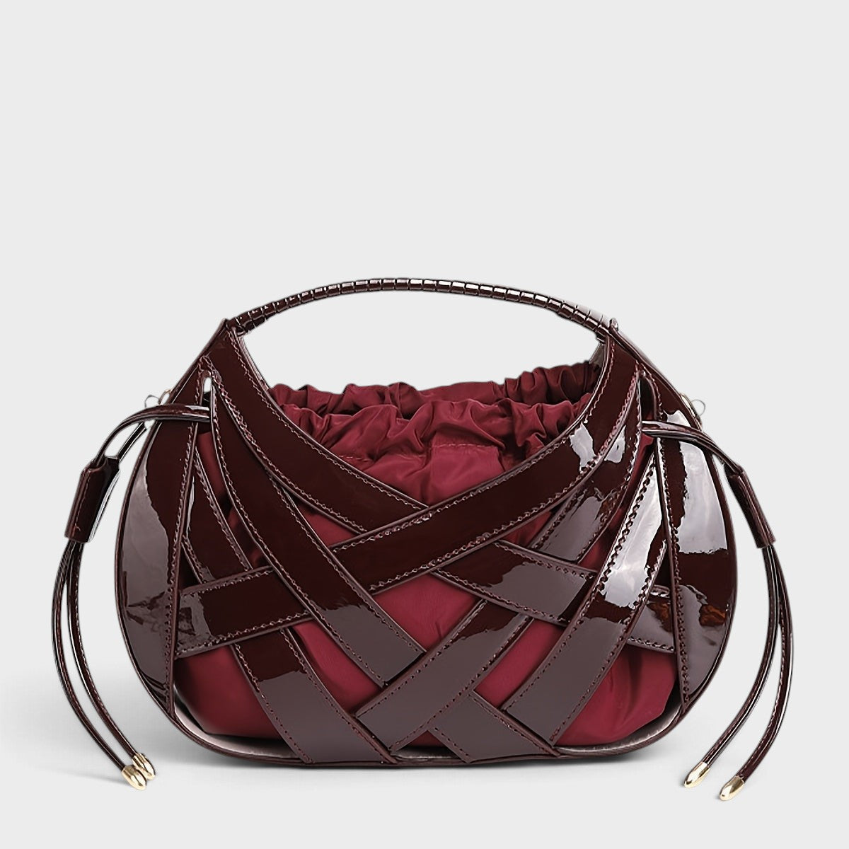 VALENORA Ruby handbag in deep burgundy vegan leather with a structured lattice overlay and soft drawstring pouch.