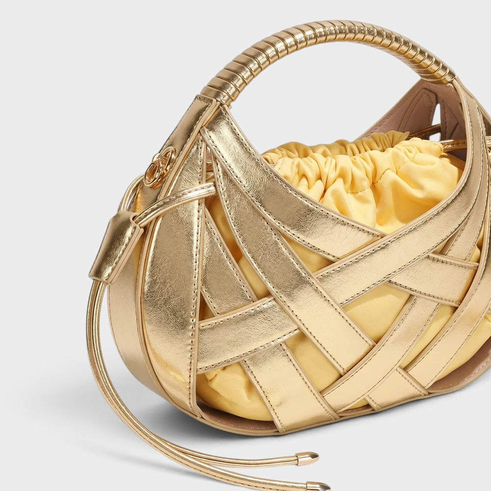 VALENORA Ruby handbag in metallic gold vegan leather with an architectural lattice overlay and soft yellow pouch.