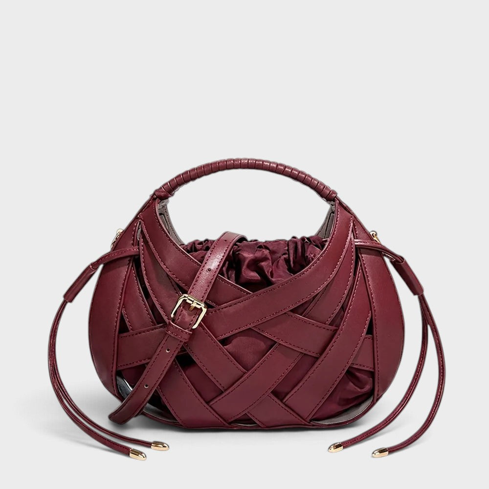 VALENORA Ruby handbag in deep red vegan leather featuring a structured lattice overlay and soft drawstring pouch.