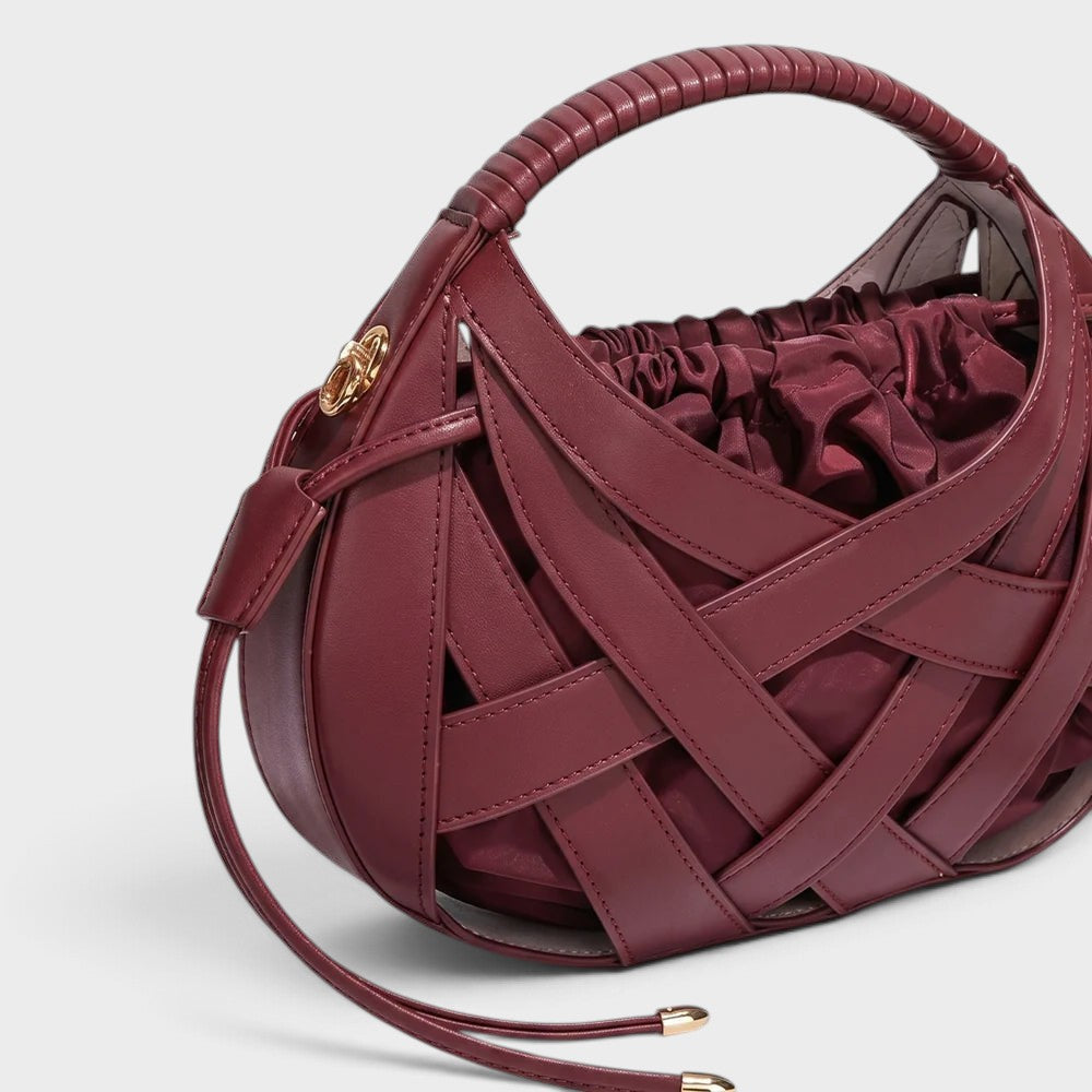 VALENORA Ruby handbag in deep red vegan leather featuring a structured lattice overlay and soft drawstring pouch.