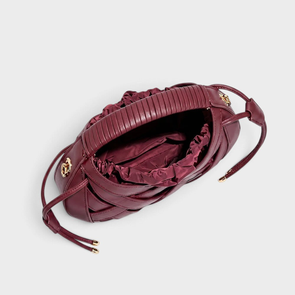 VALENORA Ruby handbag in deep red vegan leather featuring a structured lattice overlay and soft drawstring interior.