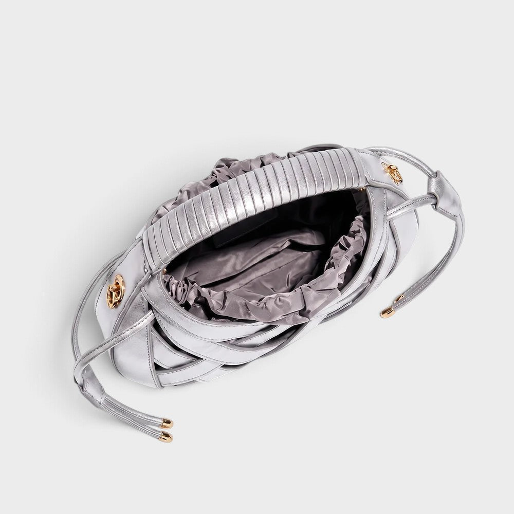 VALENORA Ruby silver vegan leather handbag featuring an architectural lattice overlay and a soft drawstring interior.