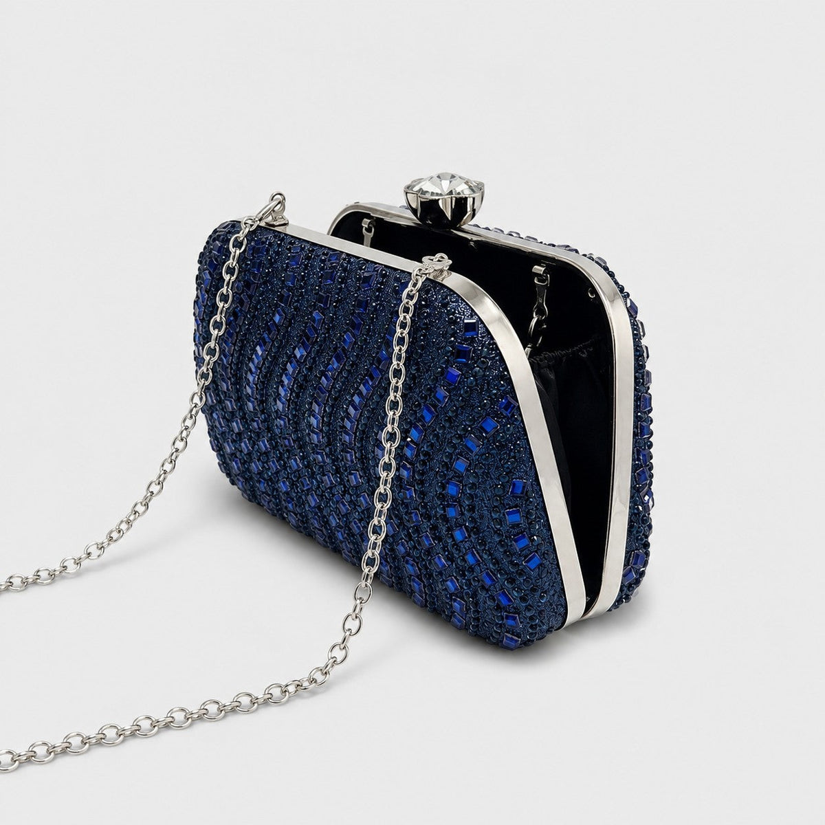 VALENORA Séraphine navy blue crystal-encrusted evening clutch bag with a silver chain strap and crystal clasp.