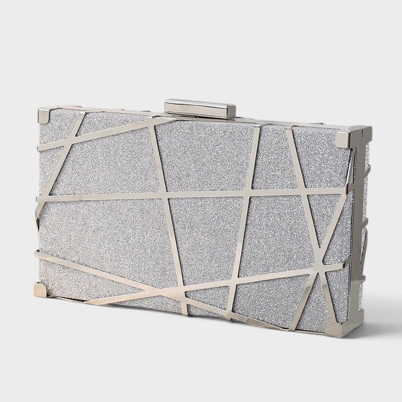 VALENORA silver metallic geometric clutch with a sharp angular design and a sparkling glitter finish.