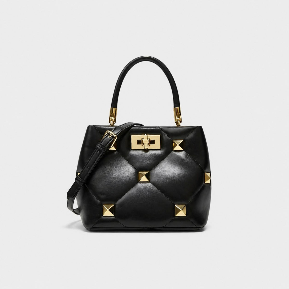 VALENORA Stella black quilted leather handbag with gold pyramid stud hardware and structured architectural design.