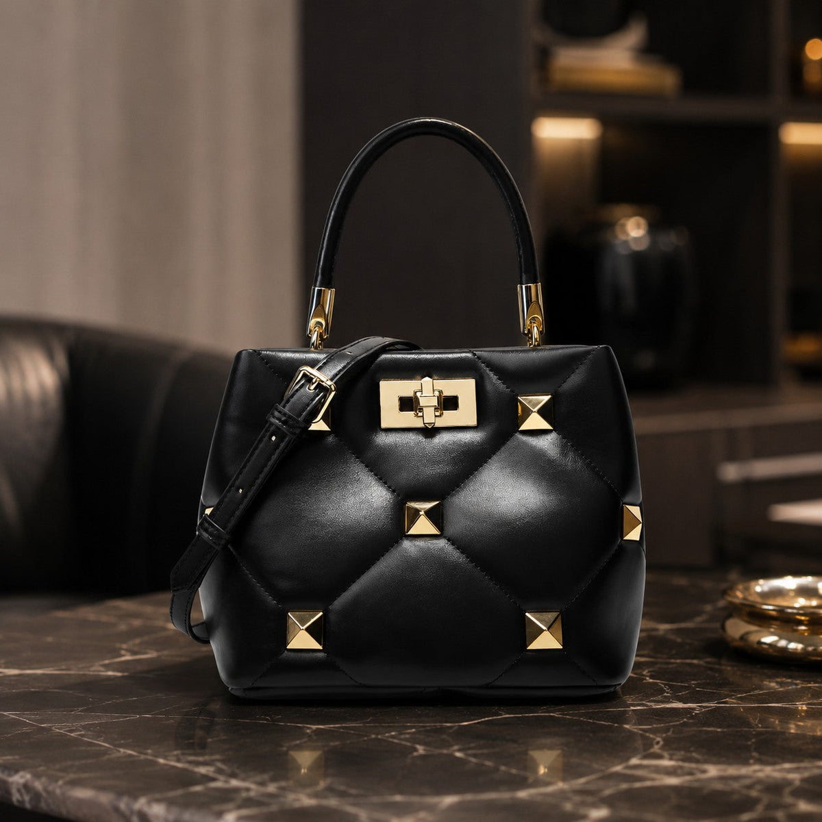 VALENORA Stella black genuine leather handbag with quilted texture, gold stud accents, and structured top handle.