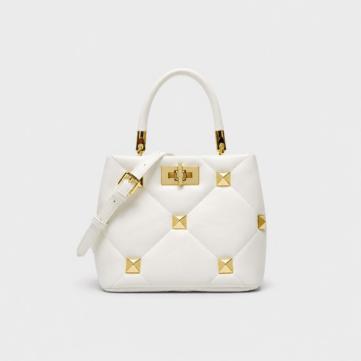 VALENORA Stella white quilted leather handbag with gold stud accents and structured architectural design.