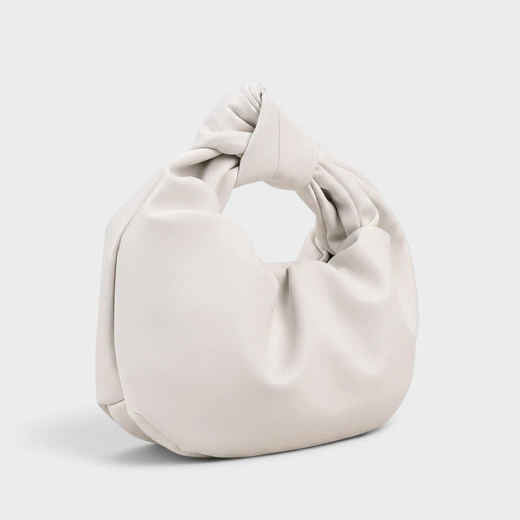 VALENORA white vegan leather handbag with a unique knotted handle design and a smooth matte finish.