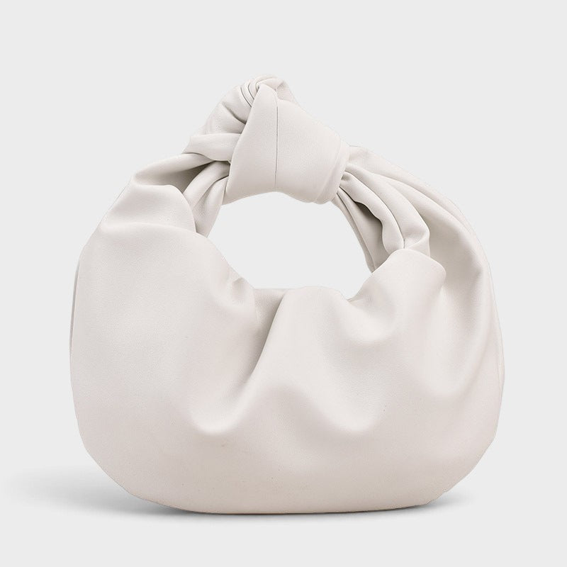 VALENORA white vegan leather handbag with a knotted top handle and a soft, slouchy matte finish.