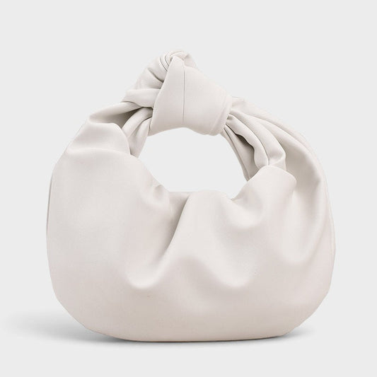 VALENORA white vegan leather handbag with a knotted top handle and a soft, slouchy matte finish.