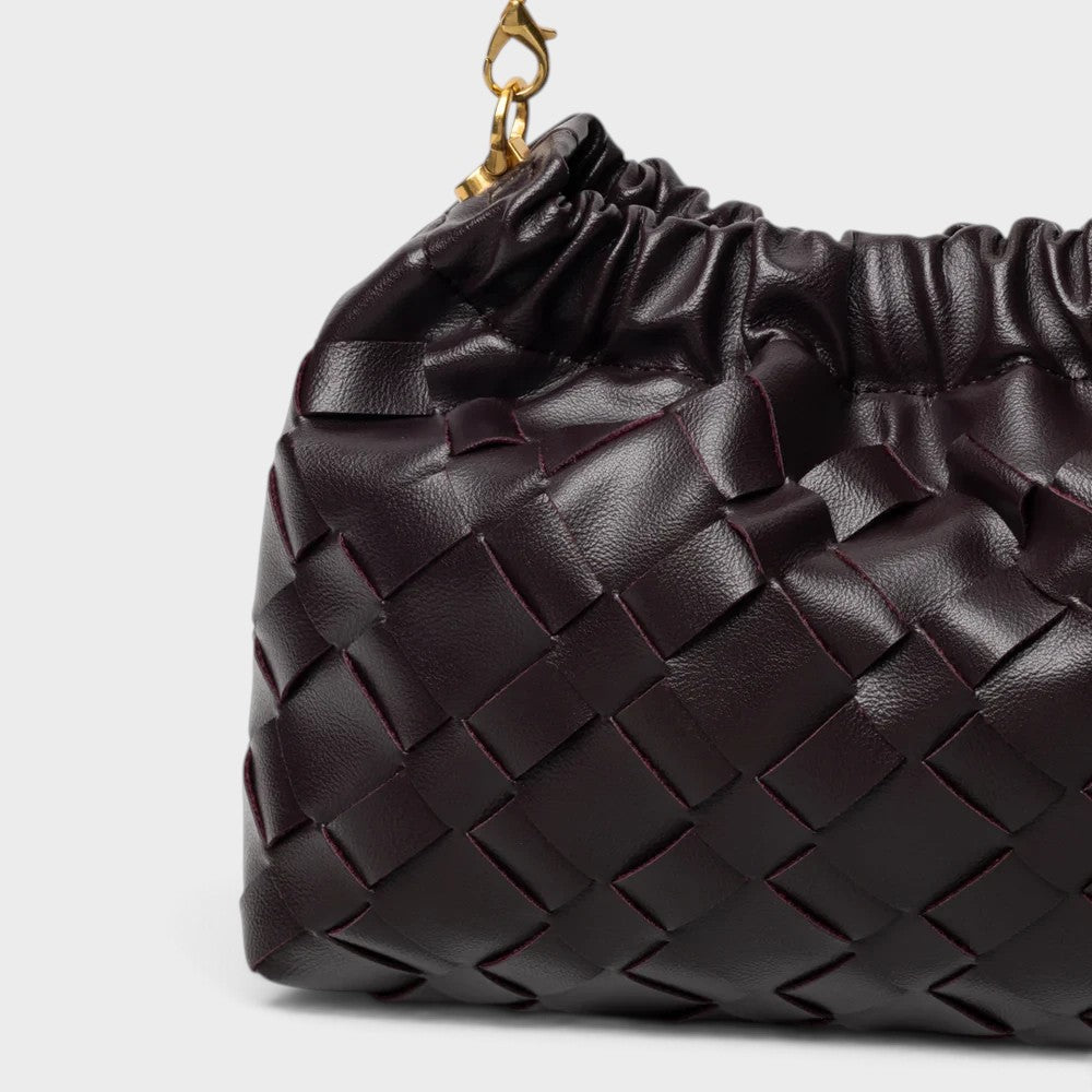 VALENORA dark burgundy woven leather shoulder bag with a gathered top and gold-tone chain strap detail.